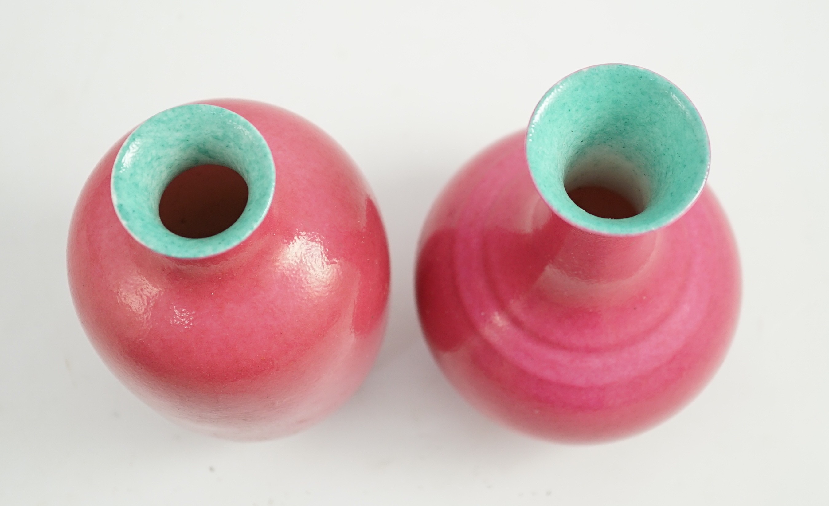 Two Chinese ruby ground vases, possibly Republic period, each with a printed four character Qianlong mark, 18.5 and 19.4cm high